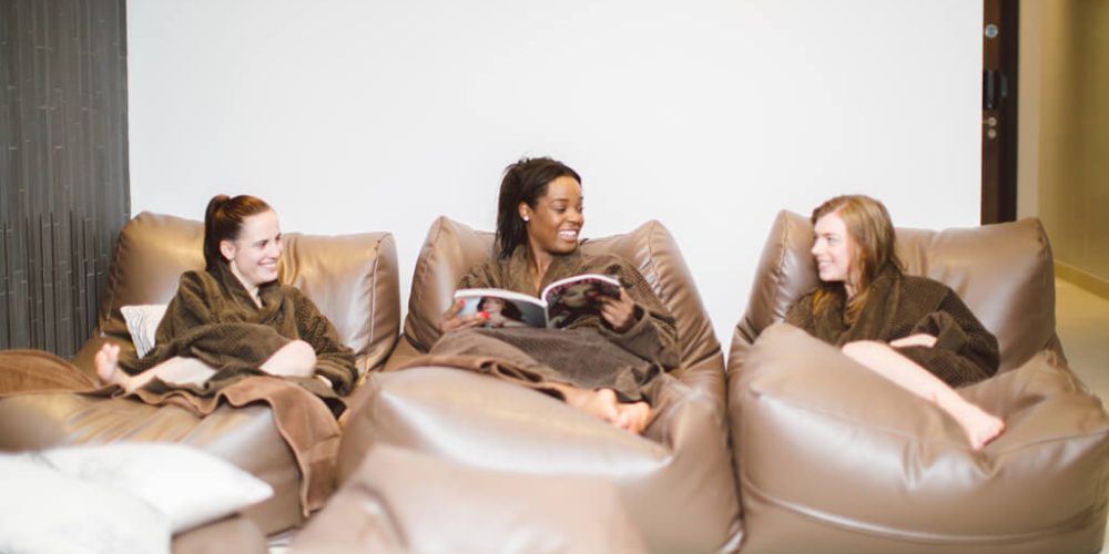 Ladies relaxing on soft chairs in relaxation area at Abbey Spa