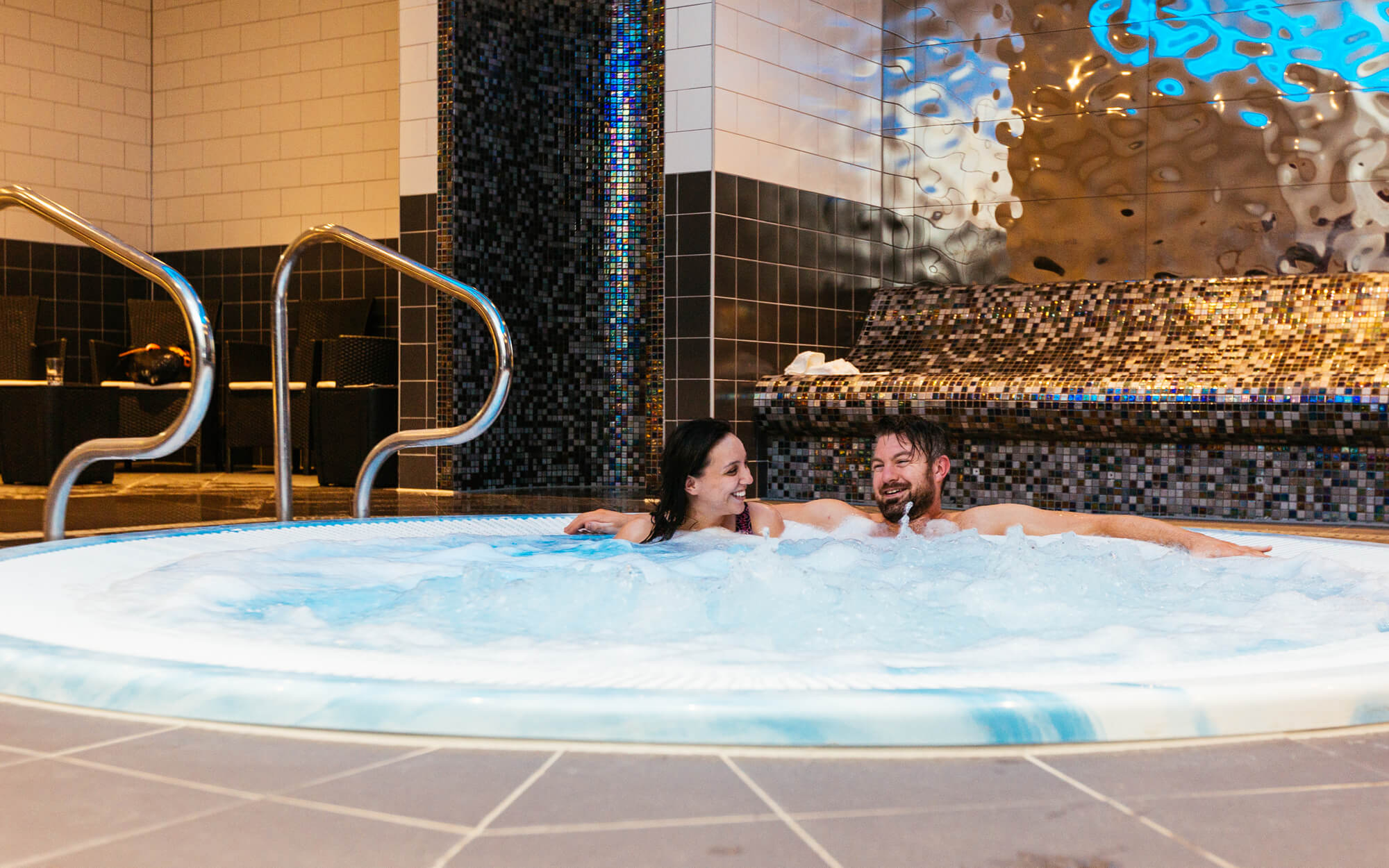 Couple relaxing in spa pool