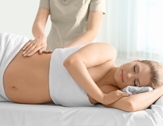 Pregnant lady enjoying relaxing massage.